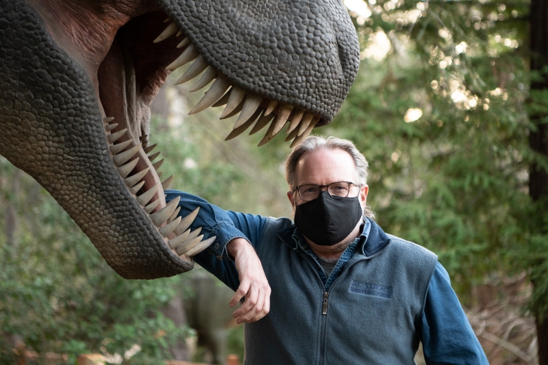  Frank Hein, Director of Exhibits & Education posing with T. rex