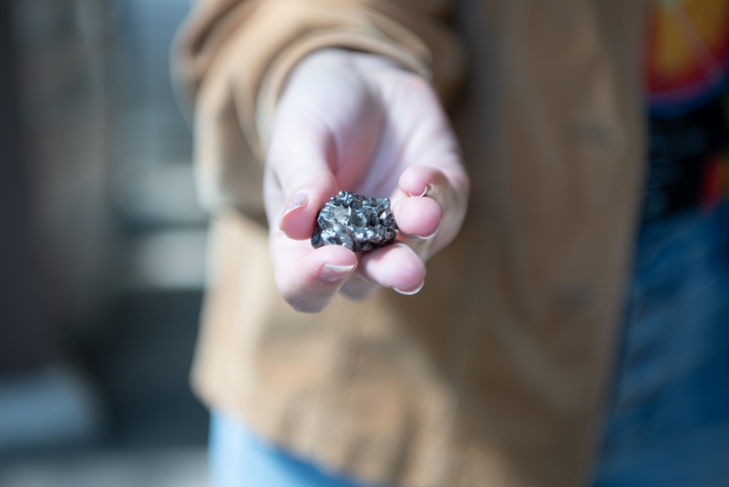 Hand holding a meteorite