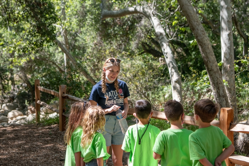 mage of instructor and line of campers in dino area