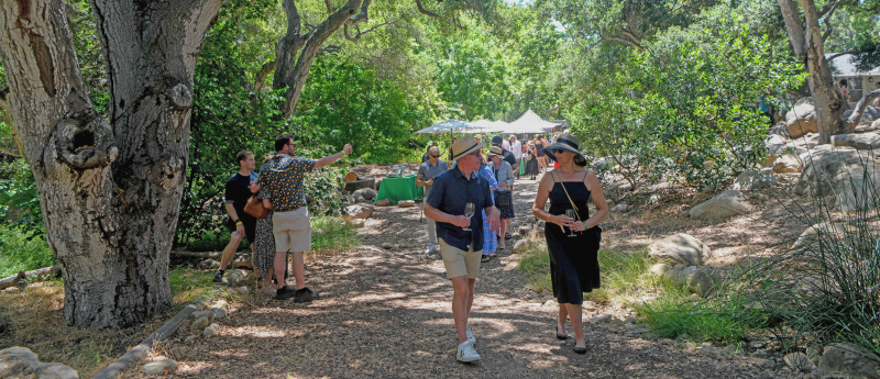 Guests enjoying wine tastings at a Santa Barbara Wine Festival fundraiser supporting education and nature