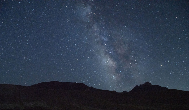 A view of the night sky so dark that you can see many stars and the outline of our galaxy known as the Milky Way