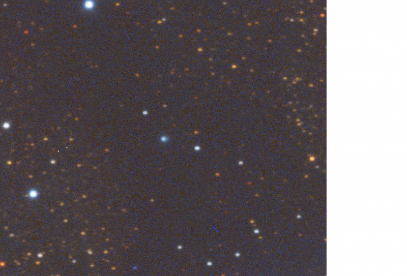An image of objects in space, appearing as colored dots of light in a dark field
