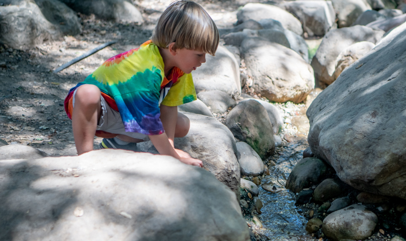 Nature Adventures camper in the Museum backyard creek