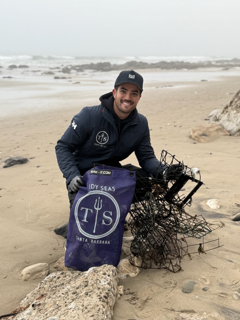 Ryan Wong on the beach collecting a lobster trap