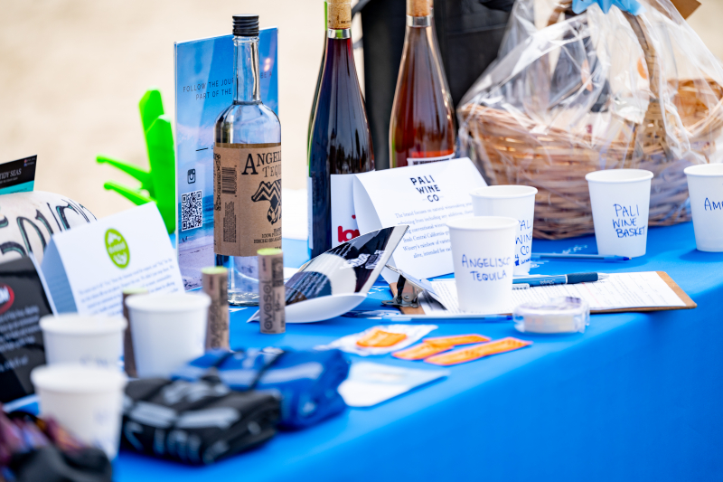Bottles and baskets of items being raffled off to beach cleanup volunteers