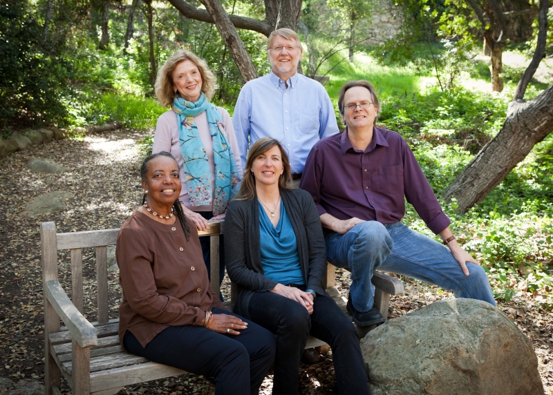 Five smiling poets in a green and gleaming oak woodland