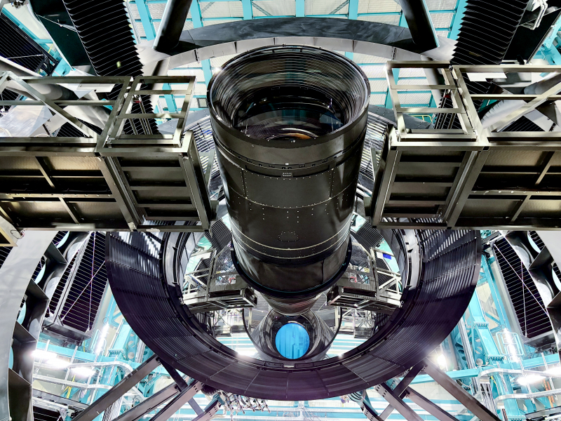view from below a gigantic camera in a huge building