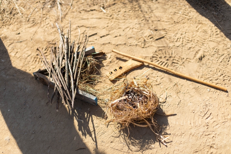 An elderberry drill, hearth of California buckeye wood, mugwort tinder, and a few other sticks provide the material to start the fire.