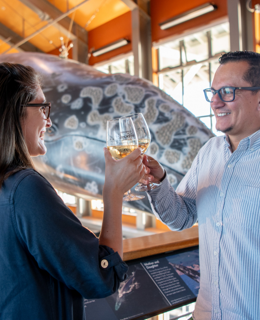 A couple having wine at the Sea Center Happy Hour event