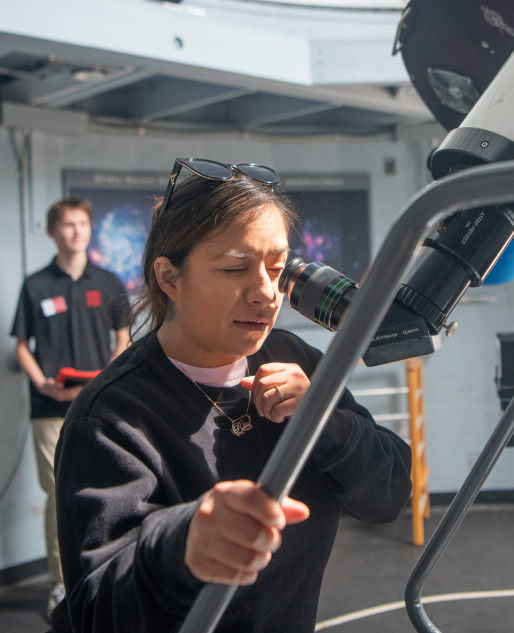 Museum visitor exploring the Gladwin Observatory telescope